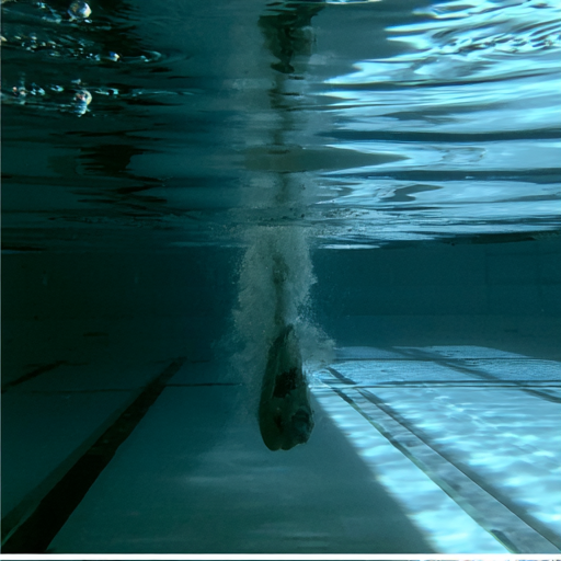 Turbulence and bubble trail left in the water behind a swimmer